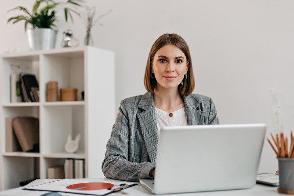 business-woman-checkered-jacket-with-smile-while-sitting-desk-her-office.jpg