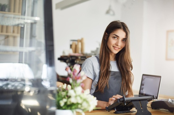 coffee-shop-owner-using-tablet-looking-camera-smiling-waiting-her-first-customer_197531-31045.jpg