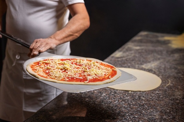 front-view-chef-preparing-pizza_23-2150235779.jpg