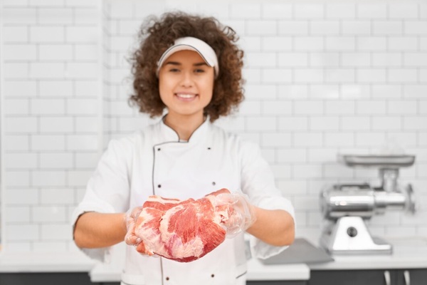 female-butcher-demonstrating-meat-supermarket_7502-4788.jpg