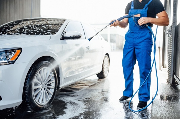 professional-washer-blue-uniform-washing-luxury-car-with-water-gun-open-air-car-wash_496169-333.jpg