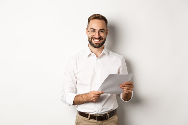 employer-looking-satisfied-with-work-reading-documents-smiling-pleased-standing.jpg