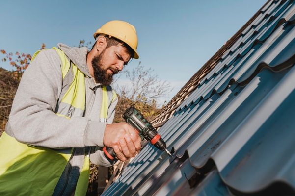 sideways-man-working-roof-with-drill_23-2148748771.jpg