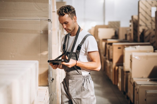 young-man-working-warehouse-with-boxes_1303-16595.jpg