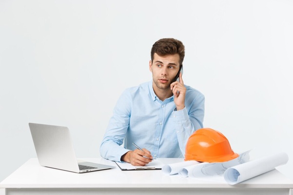 young-male-engineer-speaking-phone-his-office-grey_1258-80485.jpg