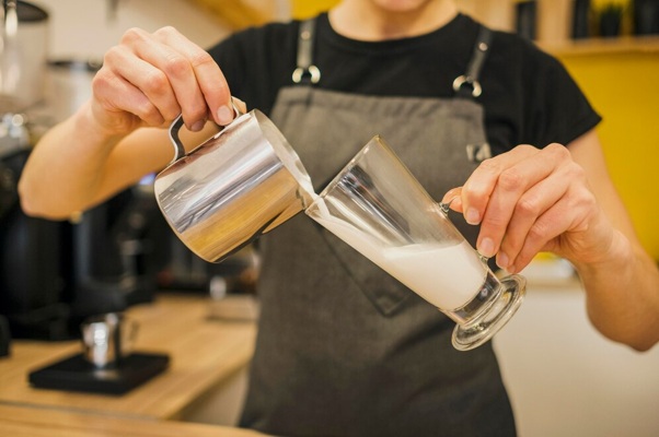 front-view-barista-pouring-milk_23-2148522997.jpg