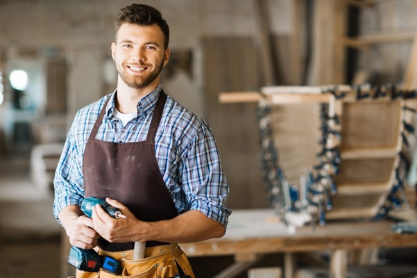 smiling-craftsman-with-electric-drill_1098-15303.jpg