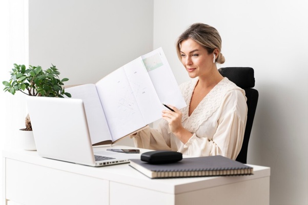 medium-shot-woman-sitting-desk_23-2149271013.jpg