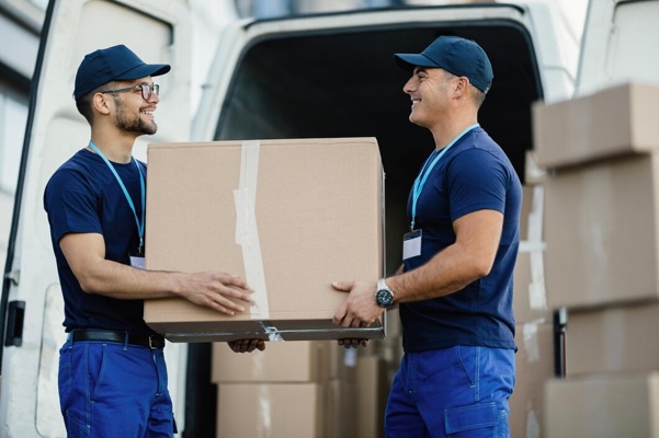 happy-manual-worker-cooperating-while-carrying-cardboard-boxes-delivery-van_637285-1258.jpg