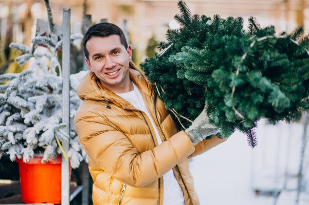 handsome-man-choosing-christmas-tree-greenhouse_1303-19523.jpg