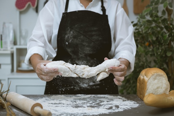 male-baker-prepares-bread-with-flour.jpg