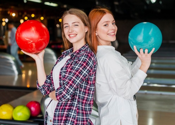 happy-women-holding-bowling-balls_23-2148344429.jpg