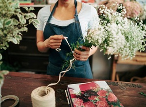 woman-s-hand-tying-bunch-flowers-with-string-shop_23-2147882098.jpg