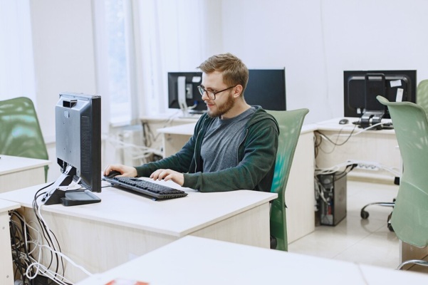 man-with-glasses-student-computer-science-class-person-uses-computer_1157-42310.jpg