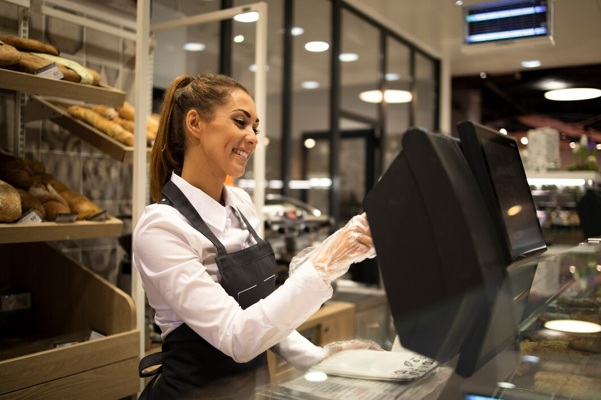 female-baker-seller-working-computer-selling-bread-supermarket_342744-1065.jpg