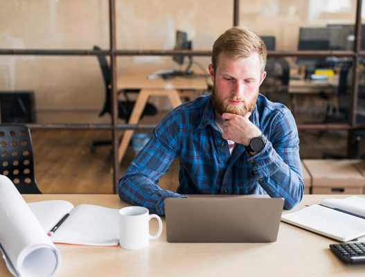 bearded-man-working-laptop-workplace_23-2148187162.jpg