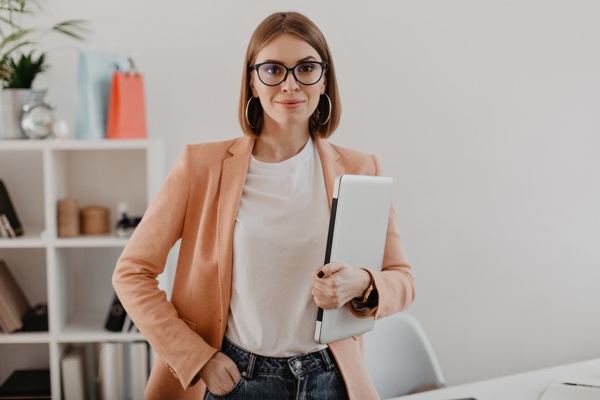 portrait-successful-business-woman-with-glasses-light-jacket-smiling-against-white-office.jpg