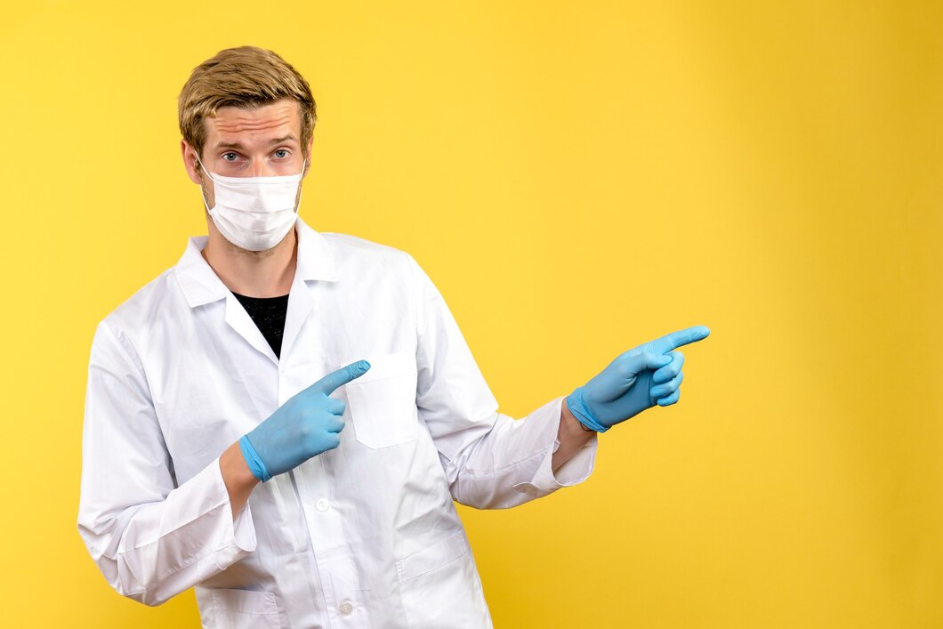 front-view-male-doctor-yellow-background-pandemic-health-covid-virus_179666-11626.jpg