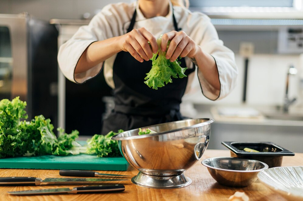 front-view-female-chef-tearing-salad-kitchen_23-2148763183.jpg