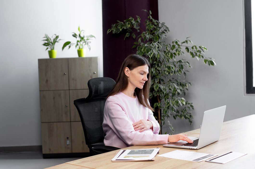 medium-shot-woman-sitting-desk_23-2149304006.jpg