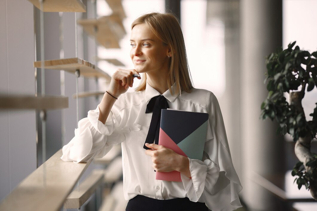 businesswoman-sitting-table-with-notebook_1157-33424.jpg