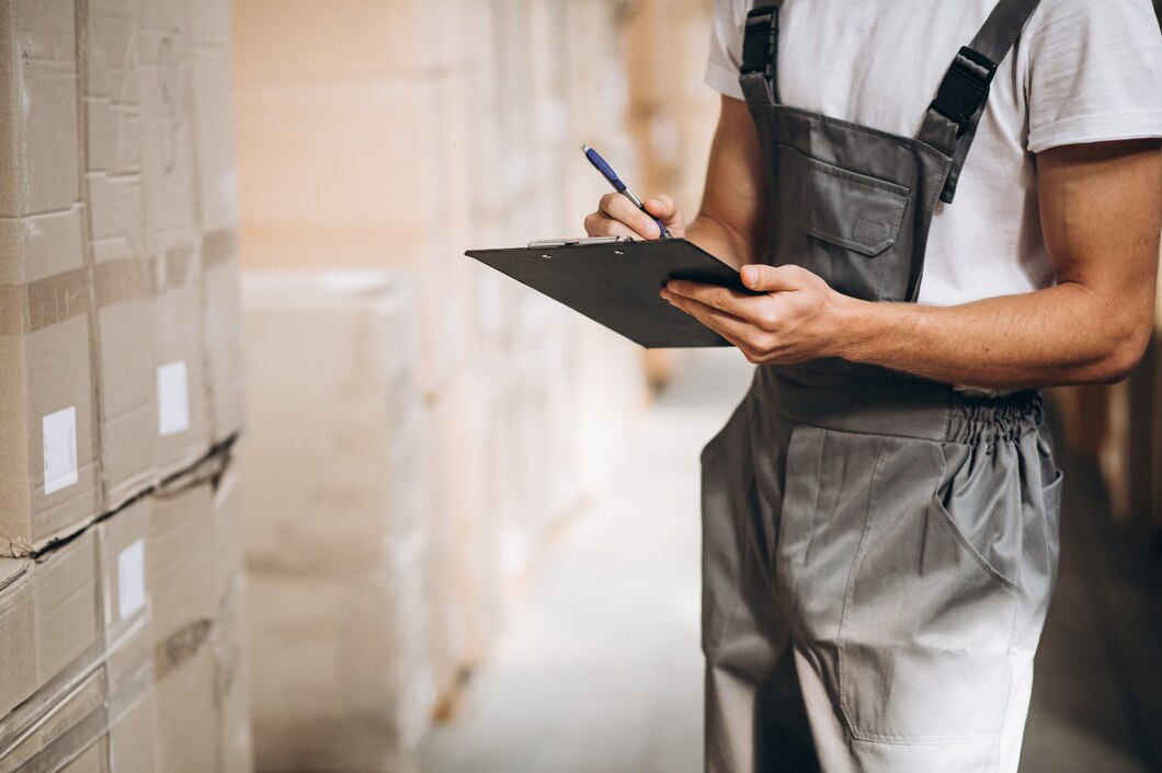 young-man-working-warehouse-with-boxes_1303-16604.jpg