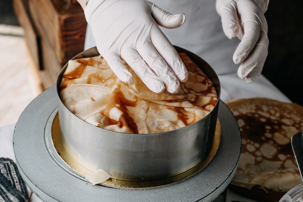 dough-inside-round-pan-with-cook-spreading-slices-cooking-meal-it-inside-kitchen_140725-14924.jpg