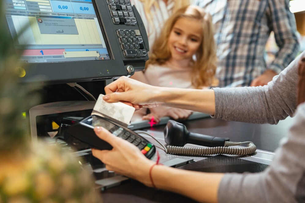 female_staff_using_credit_card_terminal_cash_counter_171337_2414.jpg