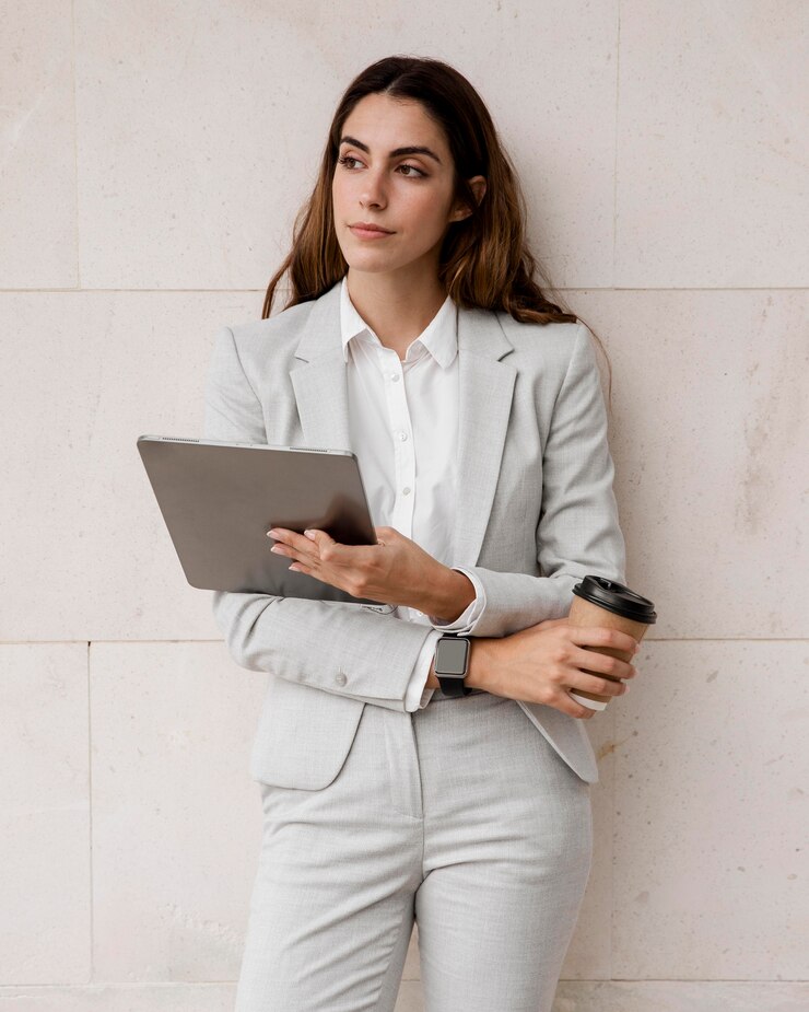 front-view-elegant-businesswoman-holding-tablet-coffee-cup_23-2148788804.jpg