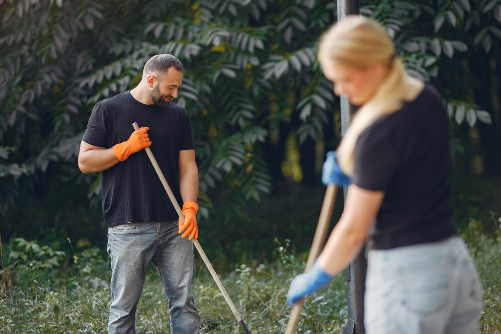 couple-collects-leaves-cleans-park_1157-27418.jpg