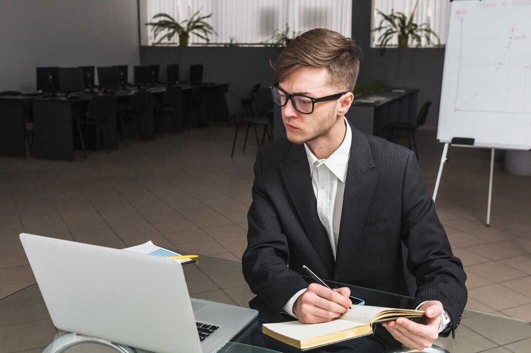 businessman-with-his-diary-looking-laptop_23-2147838582.jpg