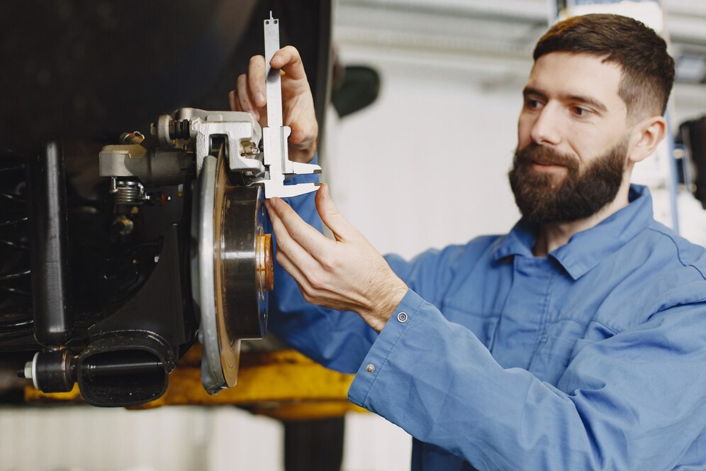 mechanic-with-tool-wheel-hands-mechanic-blue-work-clothes_1157-46153.jpg