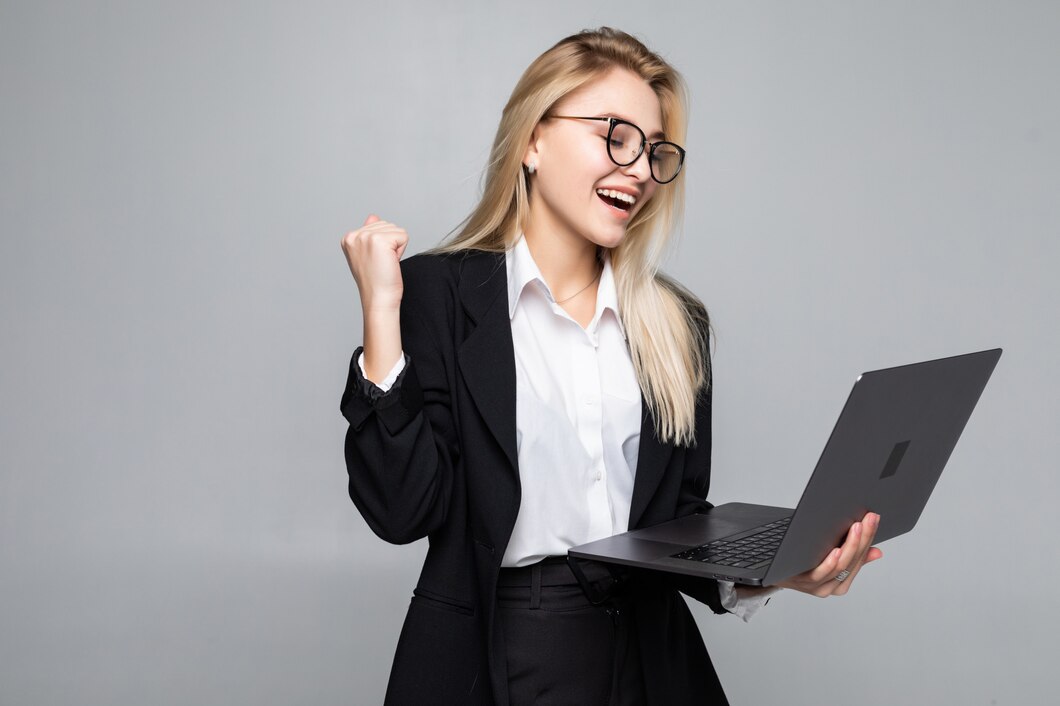 portrait-young-happy-business-woman-with-laptop-with-win-gesture_231208-245.jpg