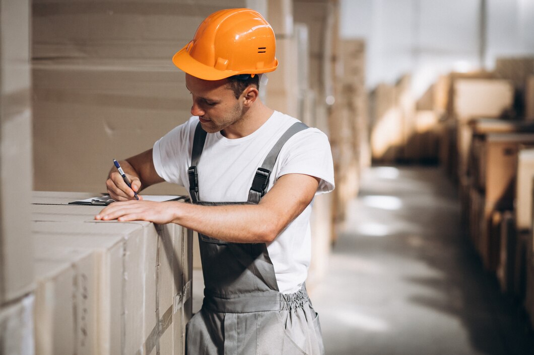 young-man-working-warehouse-with-boxes_1303-16602.jpg