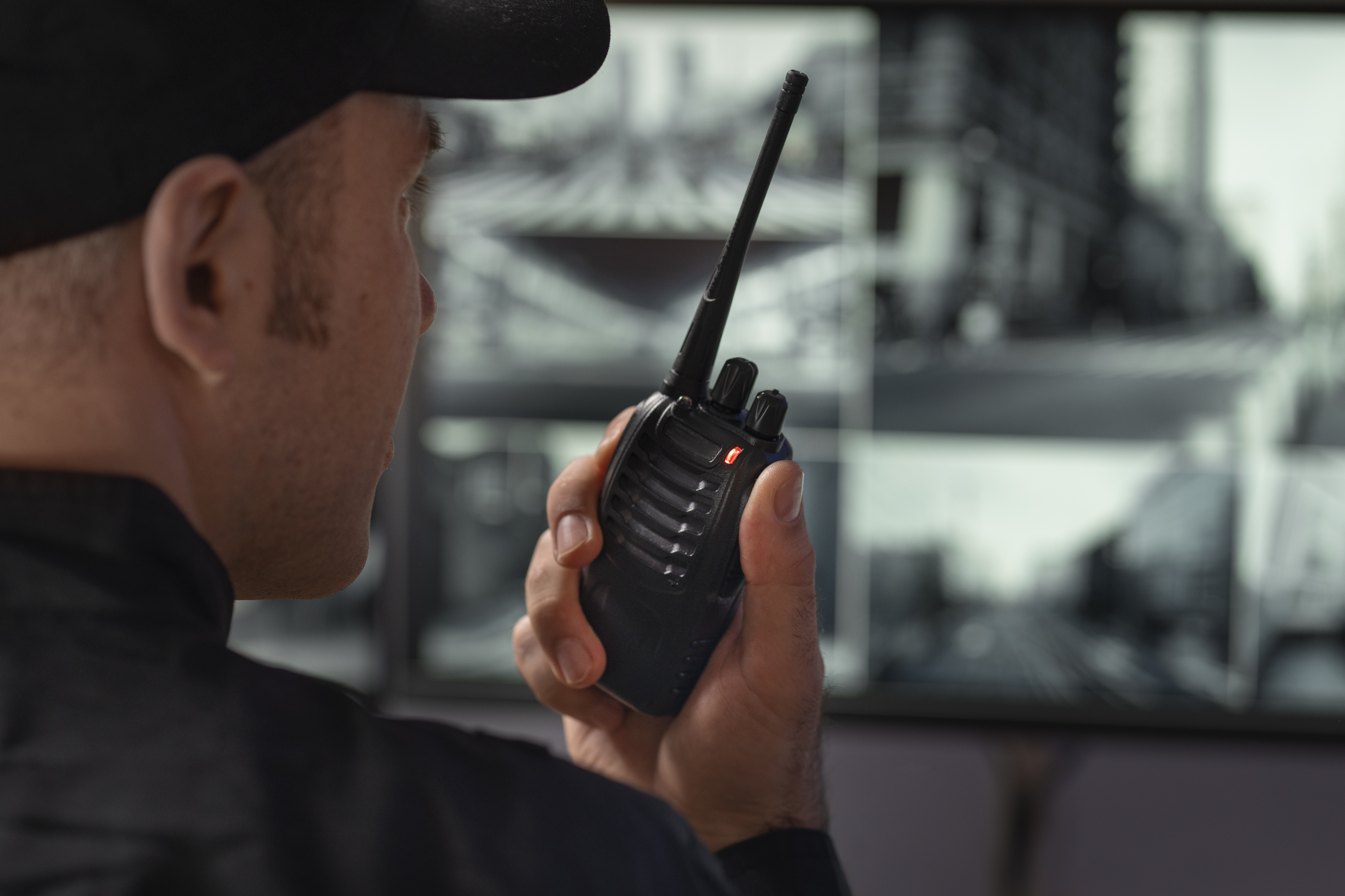 portrait-male-security-guard-with-radio-station-camera-screens.jpg