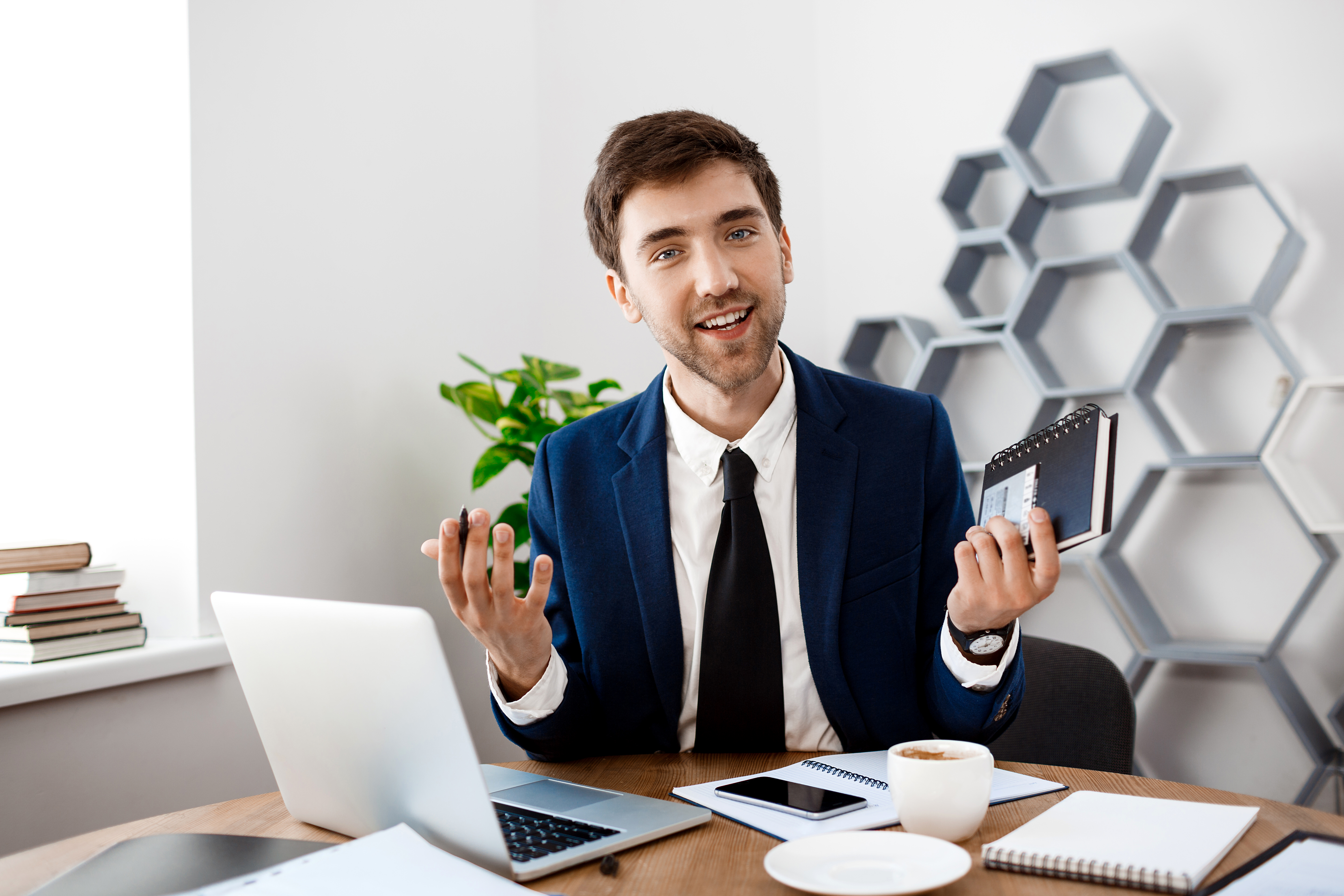 young-successful-businessman-sitting-workplace-office-background.jpg