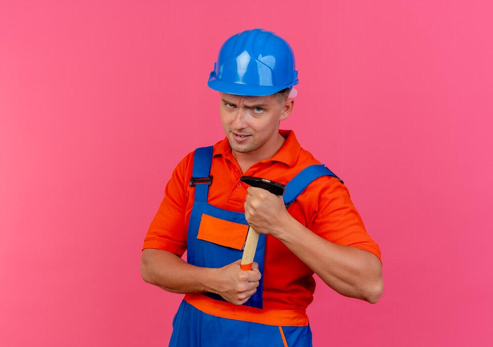 confident-young-male-builder-wearing-uniform-safety-helmet-holding-hammer_141793-80653.jpg