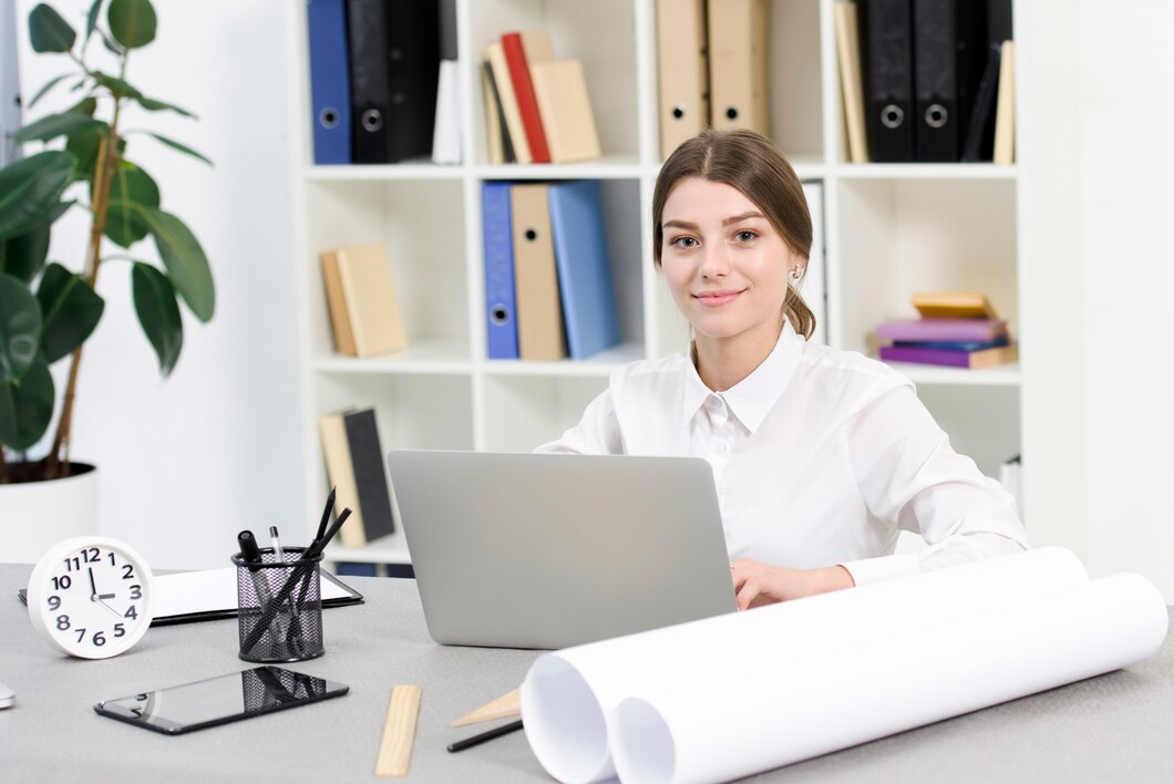 portrait-smiling-young-businesswoman-using-laptop-office_23-2148073291.jpg