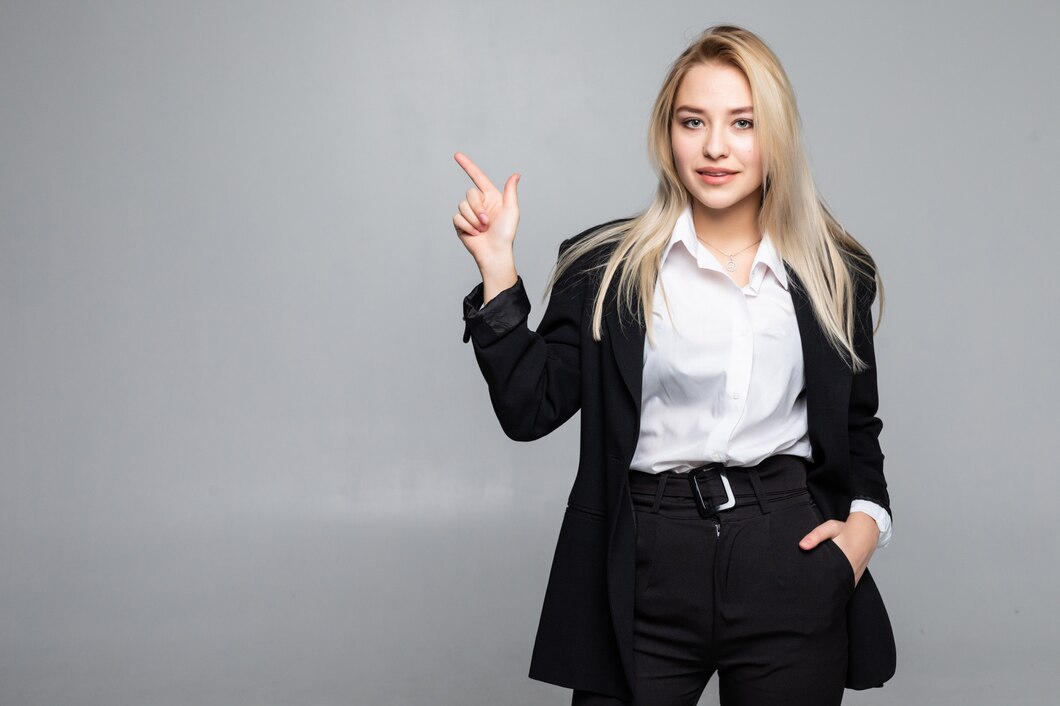 young-business-woman-pointing-finger-side-isolated-grey-wall_231208-226.jpg